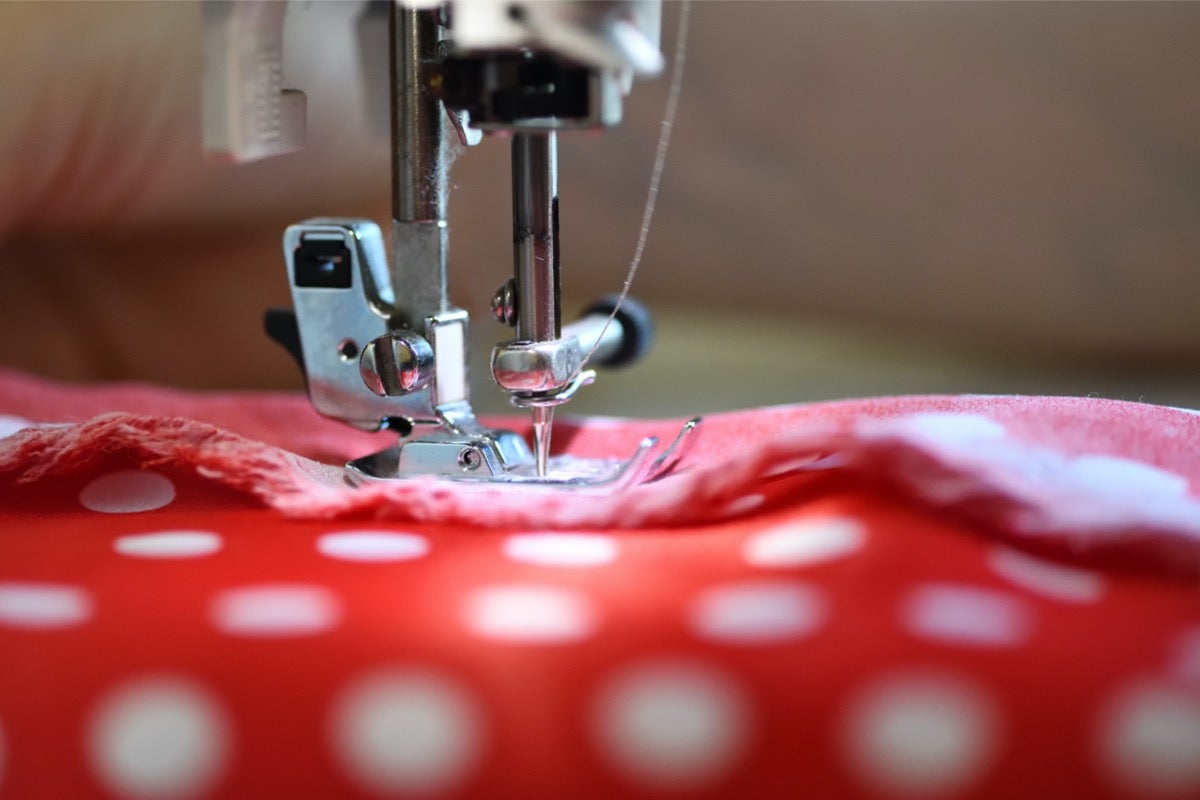 machine sewing red fabric